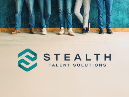 Five people stand against a teal wall, visible from the knees down. They wear various jeans and shoes, reflecting casual styles. The image foreground features a stylized logo with a teal and white emblem next to the text 